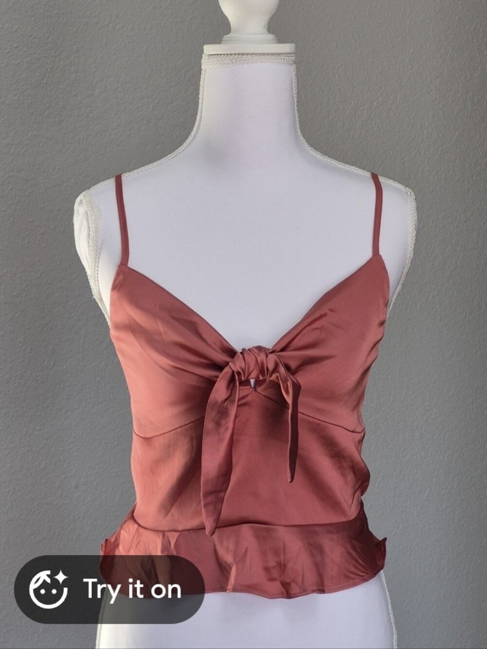 rust-colored spaghetti strap camisole features a tie-front detail